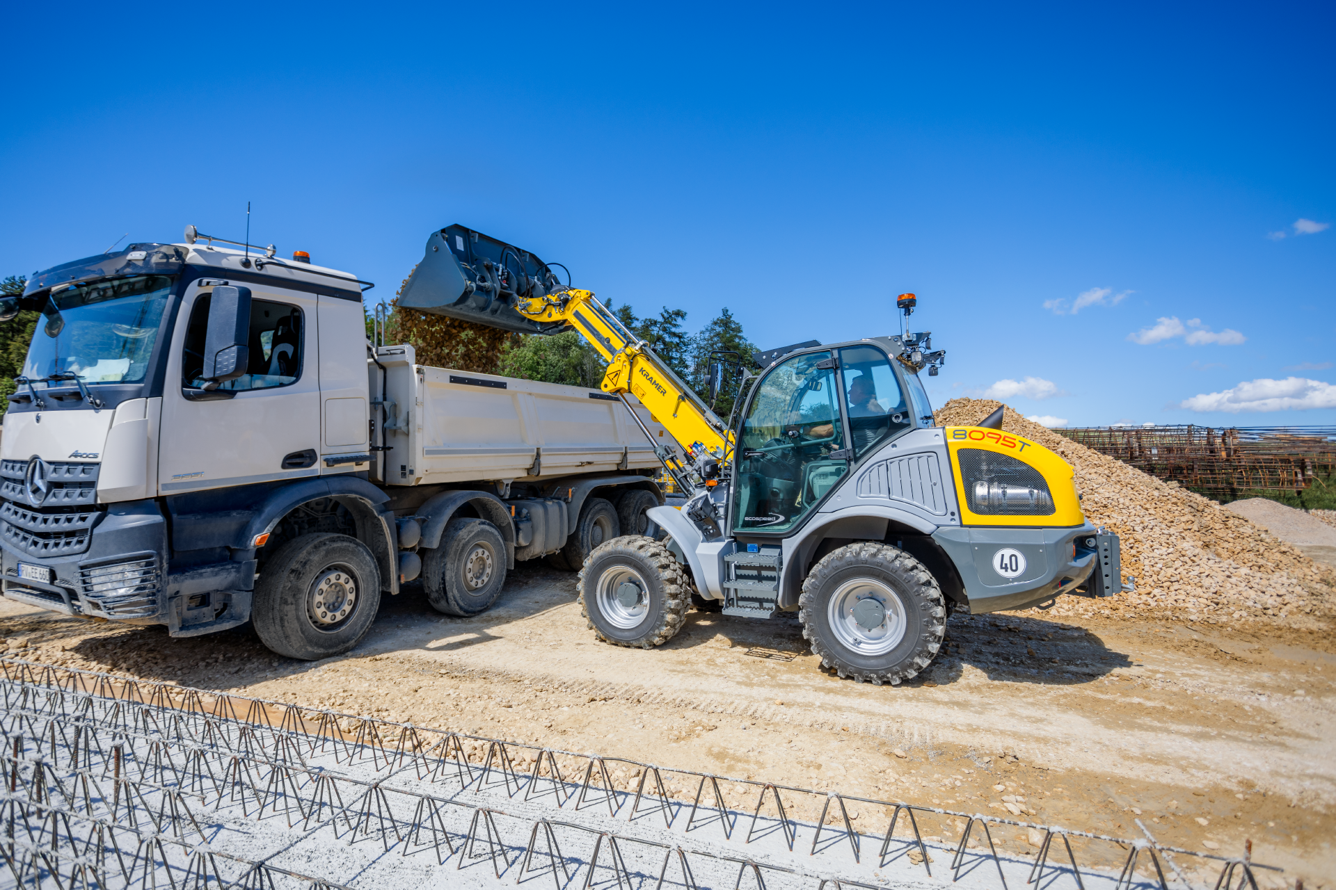 The Kramer telescopic wheel loader 8095T while dumping stones.