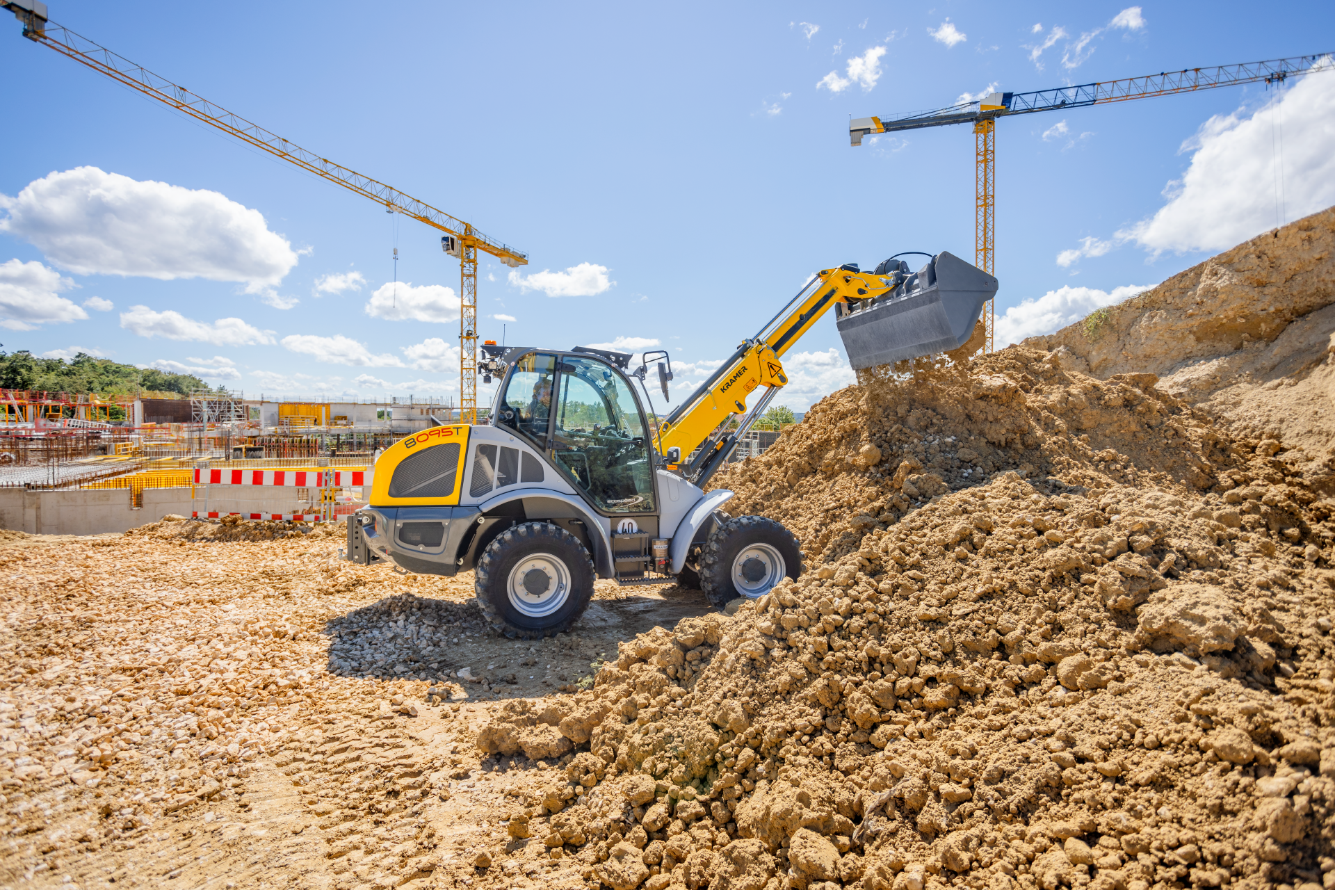 The Kramer telescopic wheel loader 8095T while working with soil.